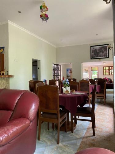 a living room with a table and a couch at Sangana Lodge in Moshi