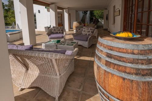 a large wooden barrel with chairs and a bowl of bananas at Eden Studios in Riebeek-Kasteel