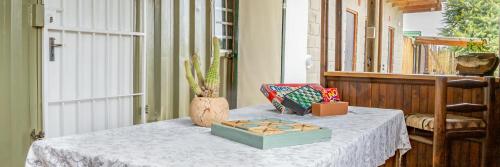 a table with a white table cloth and a box on it at Klein Plekkie Self Catering Accommodation in Addo