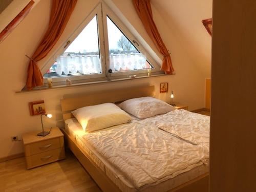 a bedroom with a bed with a large window at Schulstrasse 10a Fewo in Zingst