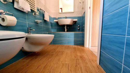 a bathroom with a white toilet and a sink at Cocos Park Ischia in Ischia