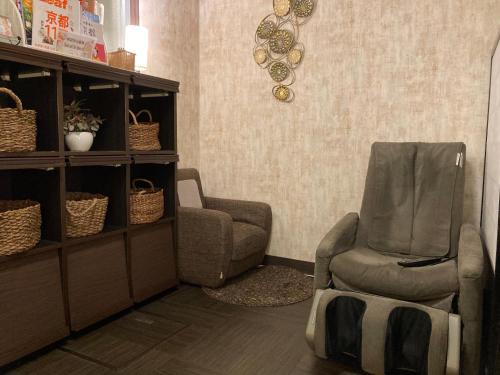 a living room with a chair and a recliner at Ryoso Chatani in Kyoto