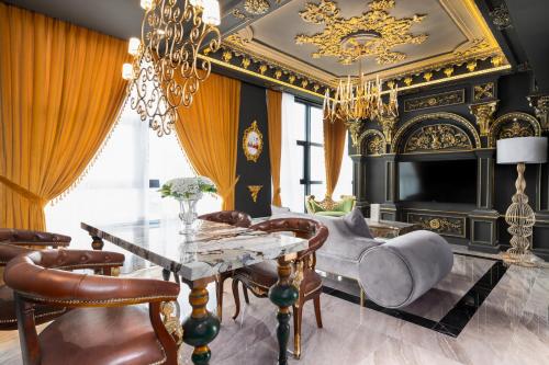 a living room with a dining table and a chandelier at arte by Thomas Chan in Kuala Lumpur