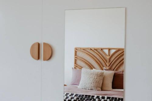 a bedroom with a bed with a wooden headboard at Coastaways in Port Campbell