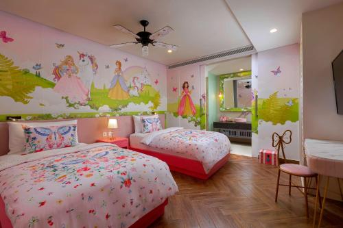 a bedroom with two beds and a princess mural at Anantara Vacation Club Mai Khao Phuket in Mai Khao Beach