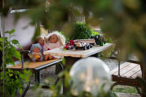 two dolls sitting on a table with toy trains on it at Casa Biagiotti in Cortona