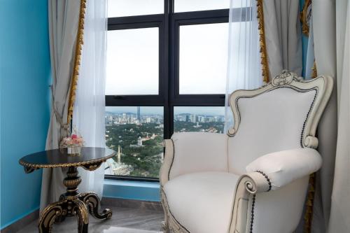a white chair in a room with a window at arte by Thomas Chan in Kuala Lumpur