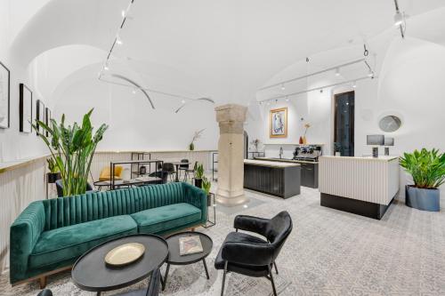 a living room with a green couch and chairs at Palace Apartments in Bratislava