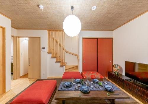 a living room with a red couch and a table at YADOYA Yanagitori East in Tokyo