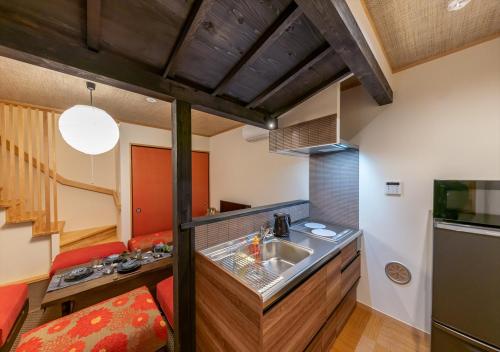 a kitchen with a sink and a counter top at YADOYA Yanagitori East in Tokyo