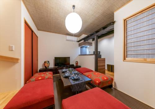 a living room with two red chairs and a table at YADOYA Yanagitori East in Tokyo