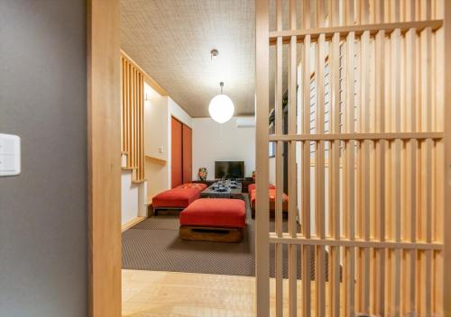 a room with a staircase and a living room at YADOYA Yanagitori East in Tokyo