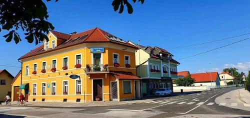 a yellow building on the side of a street at Apartment Luna in Ptuj