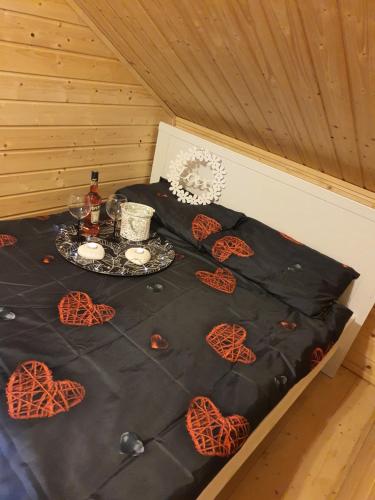 a bed with a table with hearts on it at Noclegi "LAS WYPAS" Trzcianka in Trzcianka