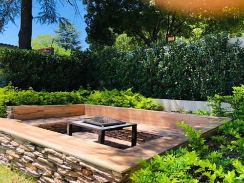 a garden with a table and a stone wall at Angel Guest House in Johannesburg