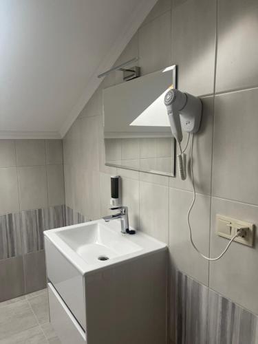 a bathroom with a white sink and a mirror at Villa Затишна de luxe in Mykulychyn