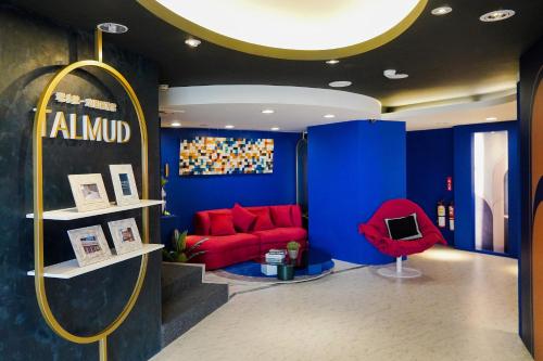 a room with a red couch and a red chair at Talmud Hotel Gongyuan in Taichung