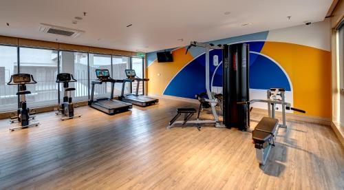 a gym with treadmills and machines in a room at Mercure Kuala Lumpur Glenmarie in Shah Alam
