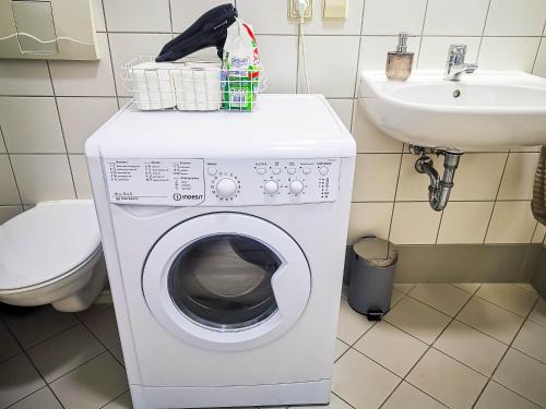 eine Waschmaschine im Bad mit Waschbecken in der Unterkunft Zwickau Innenstadt Deluxe Apartment in Zwickau