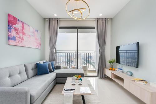 a living room with a couch and a tv at SOHO Suites - Saigon Central, 5-Min-To-Bui Vien Street in Ho Chi Minh City