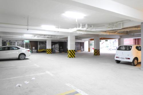 a parking garage with two cars parked in it at Luxurious Landing Apartments & Suites Bahria Town in Rawalpindi
