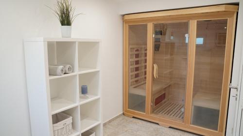 a bathroom with a wooden cabinet in a room at Die Fünf in Brodersby