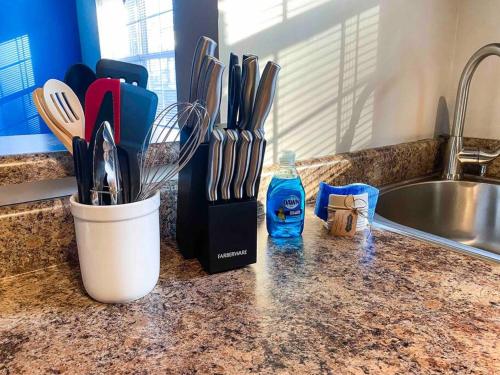 a kitchen counter with a knife block and a sink at BMW Suite King Bd,WD, Fast WiFi Free Parking, Pool, Hospitals in Atlanta