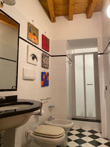 a bathroom with a toilet and a sink at CASA HERMES in Bergamo