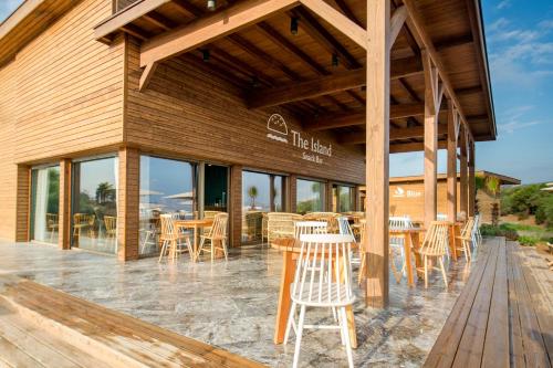 a restaurant with tables and chairs on a patio at Radisson Blu Resort Al Hoceima in Al Hoceïma