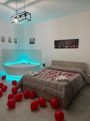 a bedroom with a large bed and a bath tub at Rosa Dei Venti Apartment in Catania