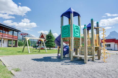 a park with a playground with a slide at Rocky Mountain Ski Lodge in Canmore