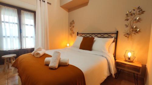 a bedroom with a bed with two towels on it at Las cuevas del agua in Chinchón