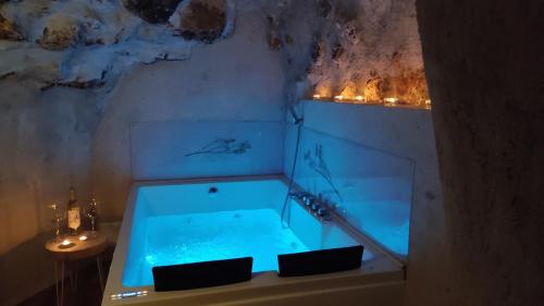 a hot tub in a room with lights at Las cuevas del agua in Chinchón