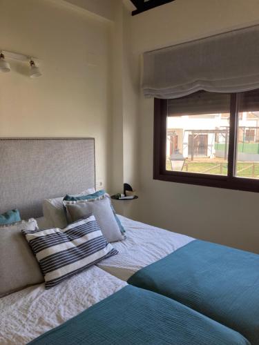 A bed or beds in a room at Bonita casa a estrenar en paraje natural a 35 minutos de Sevilla