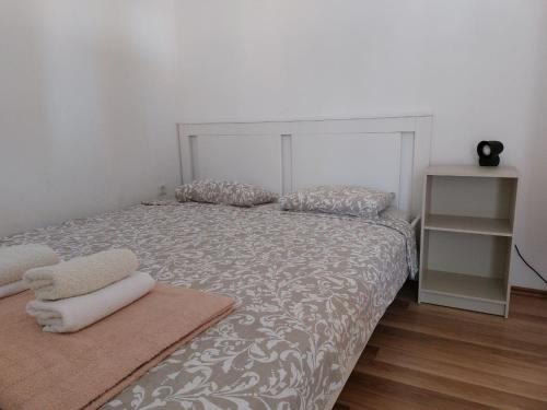 a bedroom with a bed with two pillows on it at Apartmani Dejan in Skradin