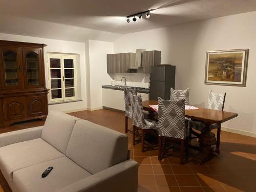 uma sala de estar com uma mesa e um sofá em Corte Storica em Cortemaggiore