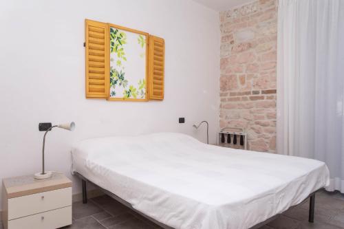 a white bed in a room with a window at A03 - Massignano, bilocale immerso nel verde 1 in Ancona