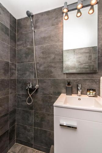 a bathroom with a sink and a shower at IKIES TINOS A and B in Tinos