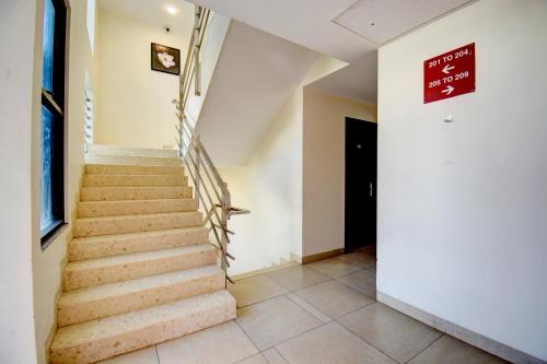 a staircase in a house with a sign on the wall at Elite Homes in Aurangabad