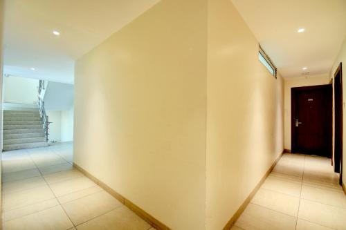 an empty hallway with stairs and a door at Elite Homes in Aurangabad