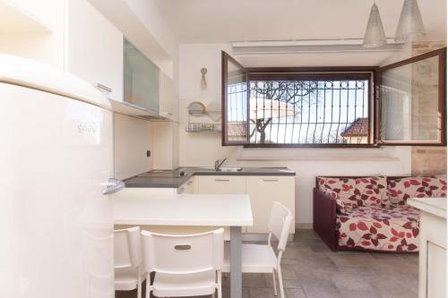 a kitchen with a table and chairs and a window at A04 - Massignano, bilocale immerso nel verde 2 in Ancona