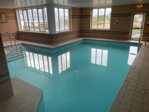 a large swimming pool in a large room at Channel View Hotel in Shanklin