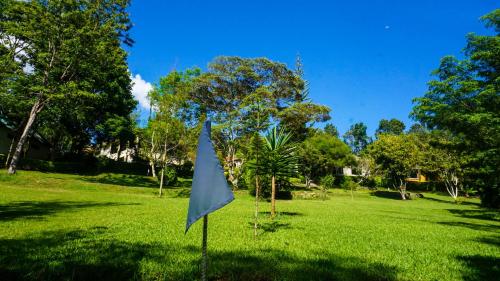 a flag in a field of grass with trees at LUSHOTO EXECUTIVE LODGE in Lushoto