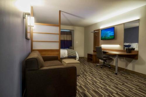 a hotel room with a bed and a desk at Microtel Inn & Suites Sault Ste. Marie in Sault Ste. Marie