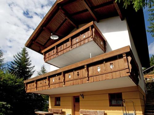 a building with a balcony on top of it at Chalet in Maria Alm in ski area with sauna in Maria Alm am Steinernen Meer
