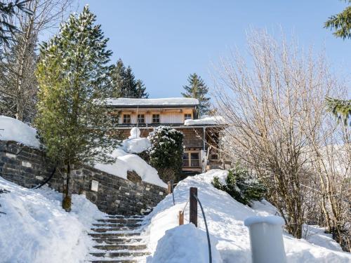 a house on a snow covered hill with stairs at Idyllic Chalet in Kaprun near Ski Area in Kaprun