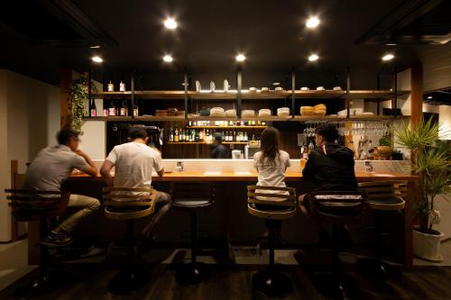 a group of people sitting at a bar at The RYOKAN O in Nakatsugawa