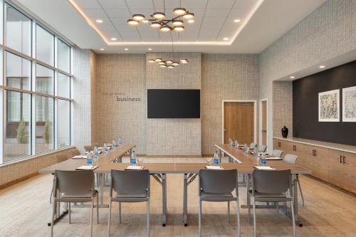 a conference room with a large table and chairs at Staybridge Suites Rochester - Mayo Clinic Area by IHG in Rochester