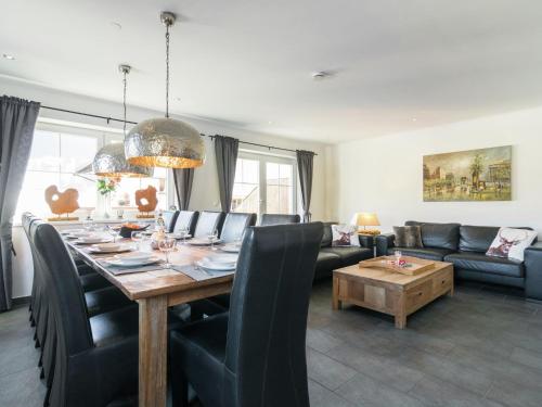 a living room with a table and a couch at Luxurious holiday home with terrace in Tyrol in Brixen im Thale