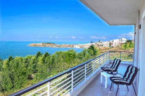 a balcony with chairs and a view of the ocean at Villa Sea View in Rethymno Town
